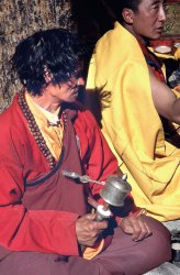 Monk spinning prayer wheel